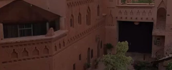 Traditional Moroccan kasbah hotel at sunset in Dades Valley with Atlas Mountains Morocco Paradijom