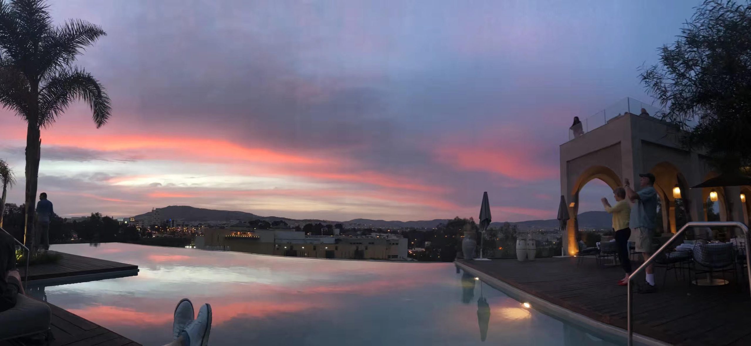 Luxury rooftop infinity pool at sunset overlooking Marrakech, Morocco